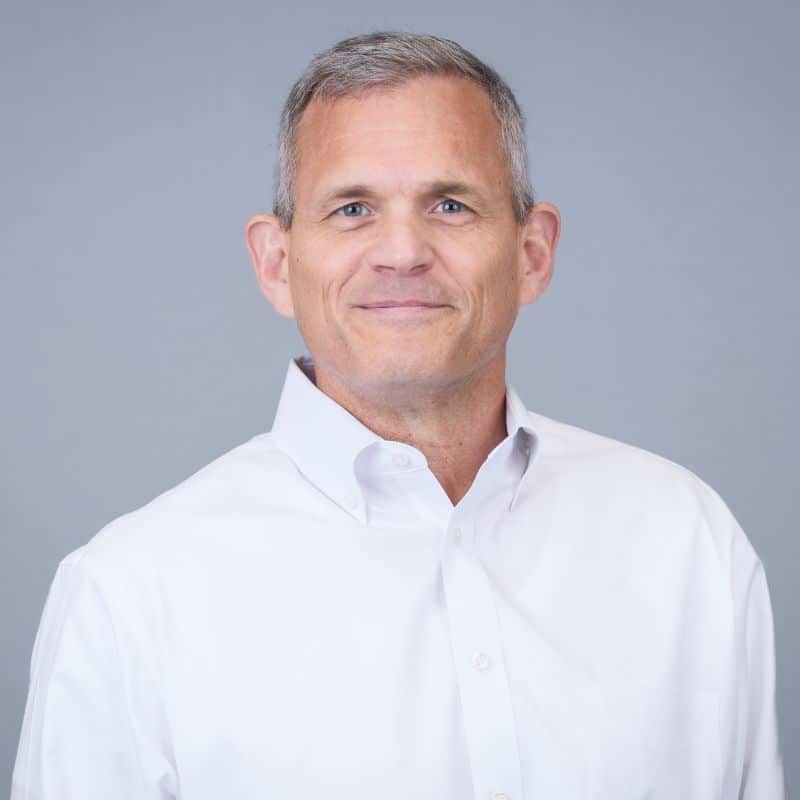 Man in white shirt, neutral background.